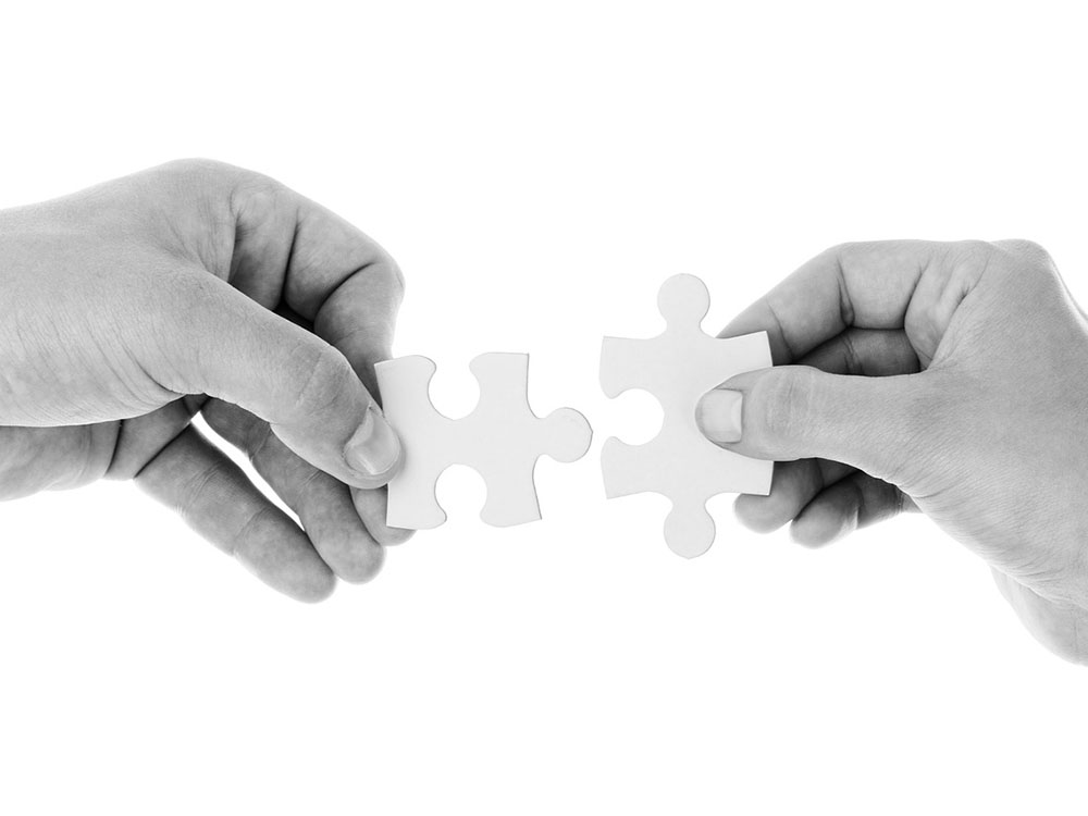 two puzzle pieces coming together to bridge challenges with document workflow software 