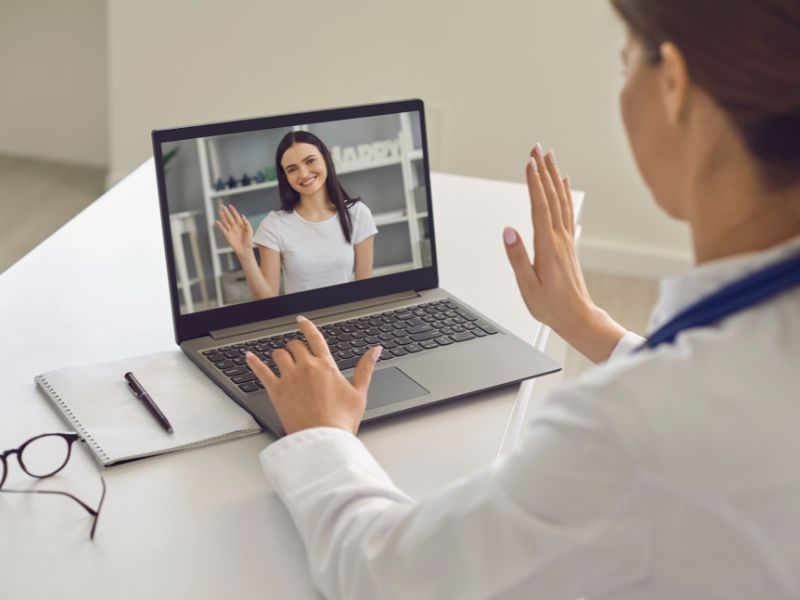doctor talking with patient virtually